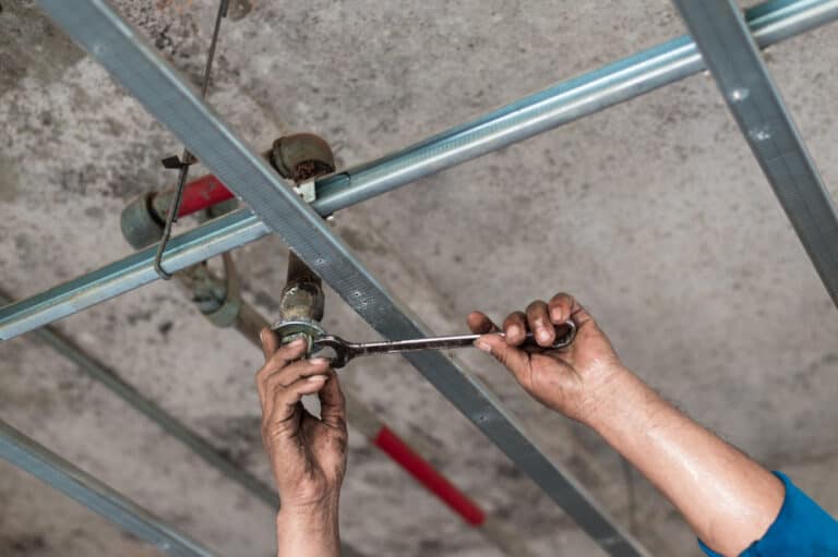 Man using a fire sprinkler head wrench