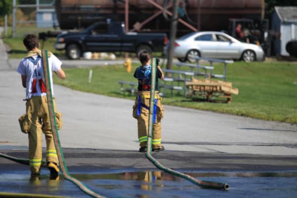 Firefighters cleaning hoses after fire event