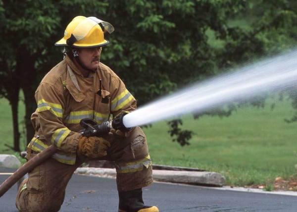 A firefighter using an attack hose.