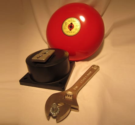 The gong, bell mechanism, bolt, and wrench used in fire alarm bell installation