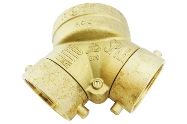 A brass fire department connection with two inlet swivels