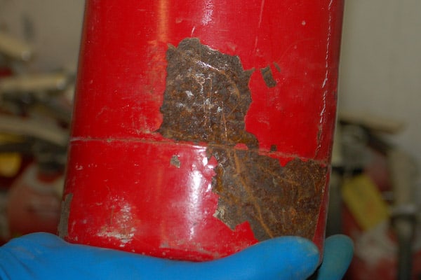 A rusty fire extinguisher fails inspection