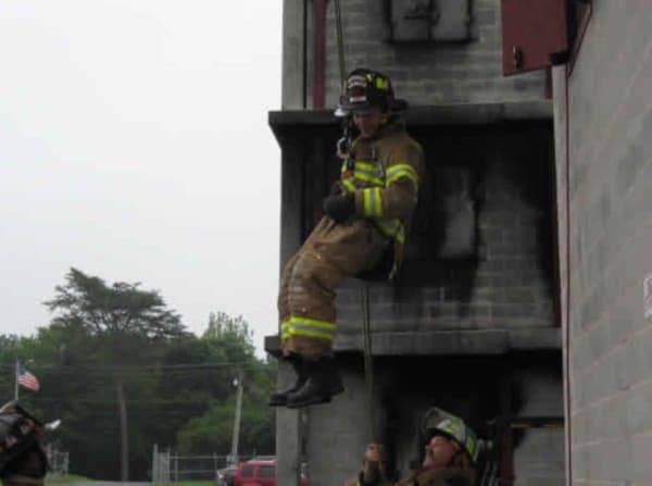 Firefighter hanging from a rope