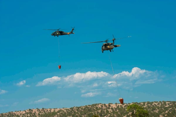 Black Hawk helicopters fighting a fire