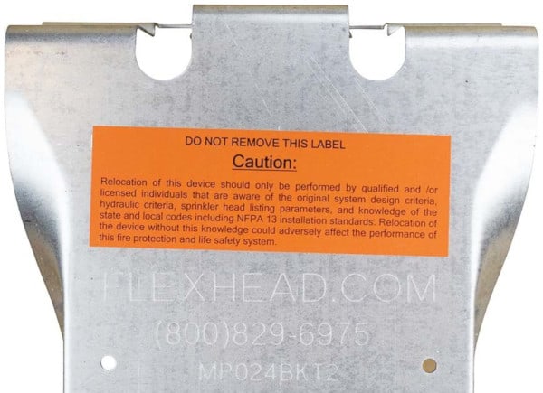 Warning label on a flexible fire sprinkler drop