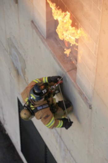 A firefighter escaping from a burning building