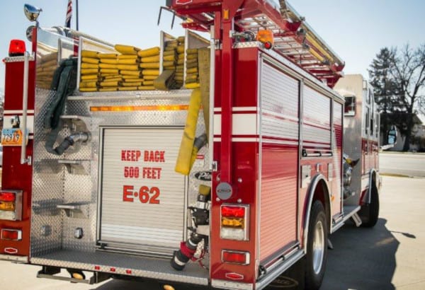 A fire truck with hose stored in the rear