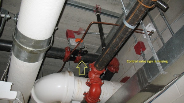 A missing control valve sign in a fire sprinkler system