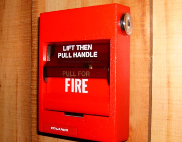 A fire alarm pull station on a wall