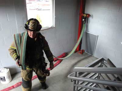 A firefighter accessing a standpipe.