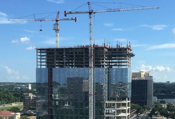 A crane towers over a hotel under construction
