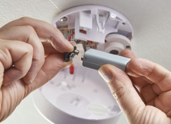 Replacing a battery in a smoke alarm