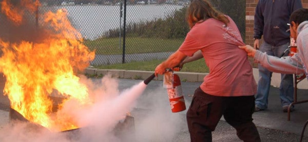 Approaching a fire with an extinguisher