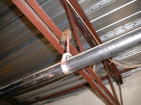 A pipe hanging from a beam clamp