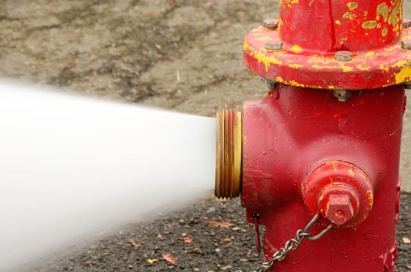 A fire hydrant spraying water