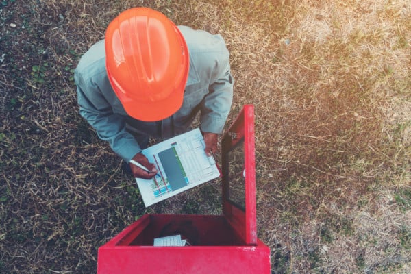 A fire extinguisher inspector using paper