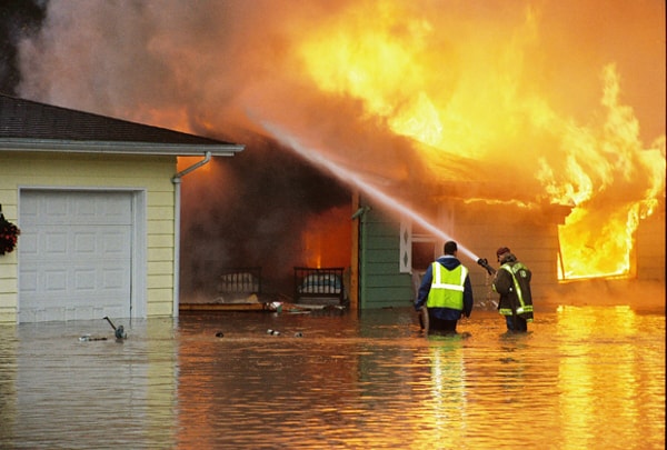 Firefighters fighting a fire during a flood