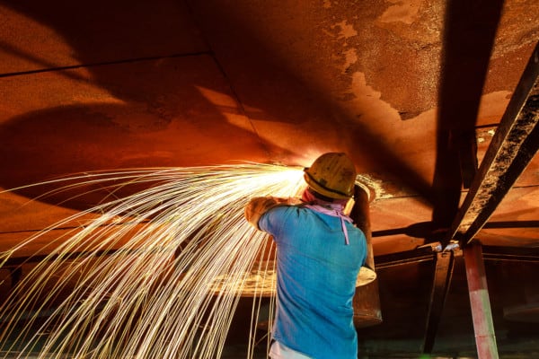Worker throwing sparks during hot work