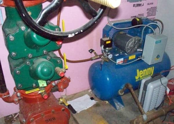Floor mounted air compressor for sprinkler system