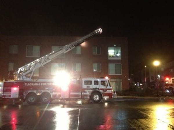 A fire engine in front of a non-burning apartment