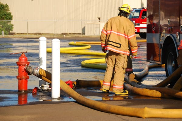 Firefighter accessing a hydrant