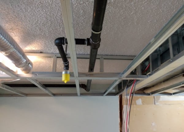 Sprinkler pipe above drop ceiling