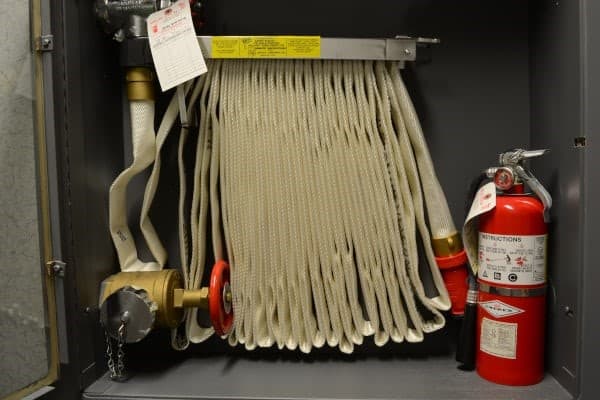 Fire extinguisher and fire hose reel in a parking building Stock