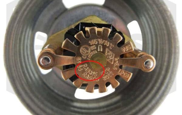 Reliable sprinkler identification number on a deflector